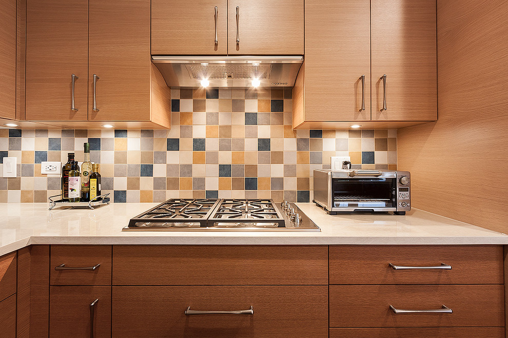 Large minimalist l-shaped medium tone wood floor and brown floor eat-in kitchen photo in Chicago with an undermount sink, flat-panel cabinets, beige cabinets, quartz countertops, multicolored backsplash, mosaic tile backsplash, stainless steel appliances, two islands and white countertops