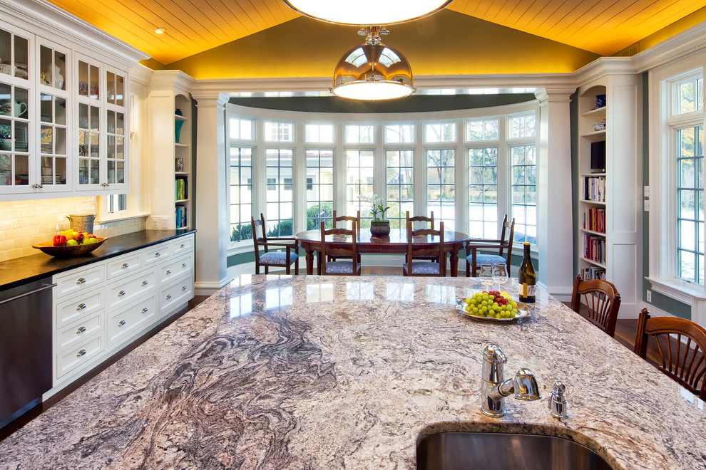 Example of a large classic l-shaped medium tone wood floor eat-in kitchen design in New York with an undermount sink, beaded inset cabinets, white cabinets, granite countertops, stainless steel appliances, an island and black countertops