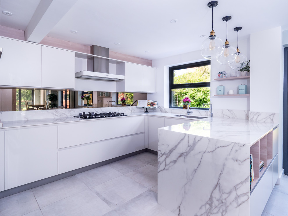 Photo of a contemporary u-shaped open plan kitchen in Berkshire with flat-panel cabinets, composite countertops, brown splashback, mirror splashback, black appliances, ceramic flooring and grey floors.