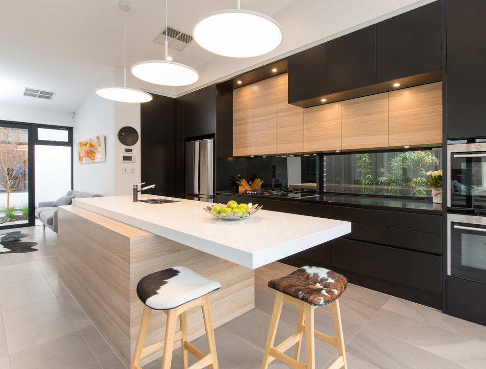 Design ideas for a contemporary single-wall kitchen in Adelaide with a submerged sink, flat-panel cabinets, black cabinets, black splashback, stainless steel appliances, an island and beige floors.