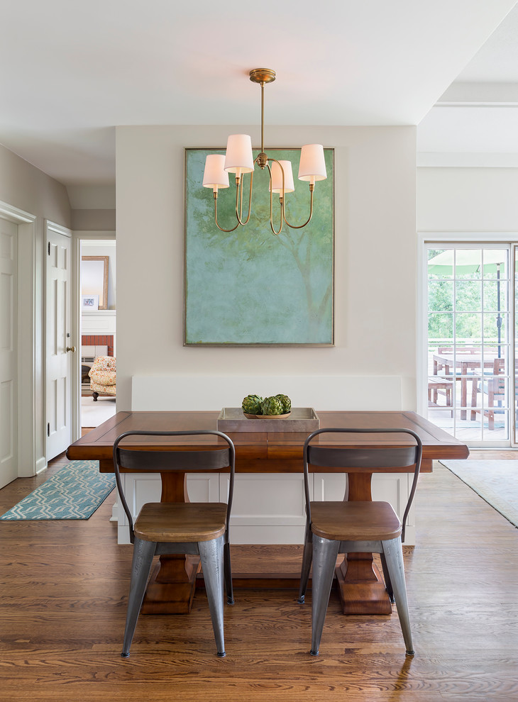 Mid-sized transitional medium tone wood floor eat-in kitchen photo in Minneapolis with a farmhouse sink, shaker cabinets, white cabinets, quartzite countertops, white backsplash, subway tile backsplash and an island