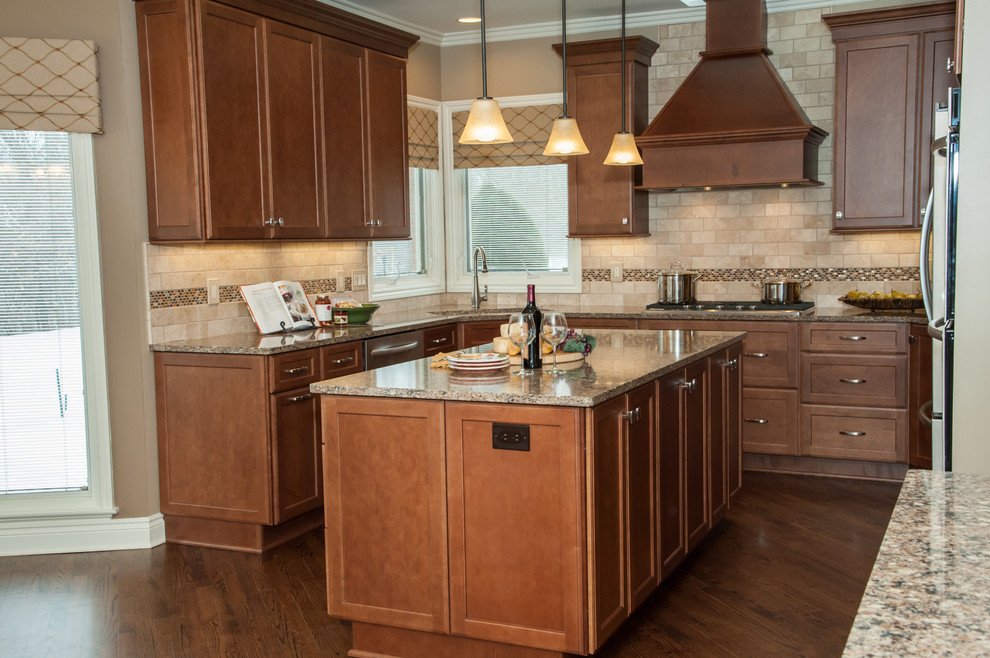 Eat-in kitchen - large traditional u-shaped medium tone wood floor eat-in kitchen idea in Detroit with an undermount sink, recessed-panel cabinets, medium tone wood cabinets, quartz countertops, brown backsplash, subway tile backsplash, stainless steel appliances and an island