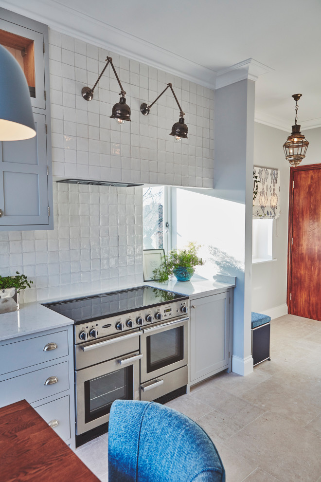 Cette image montre une cuisine américaine parallèle traditionnelle de taille moyenne avec un placard à porte shaker et îlot.