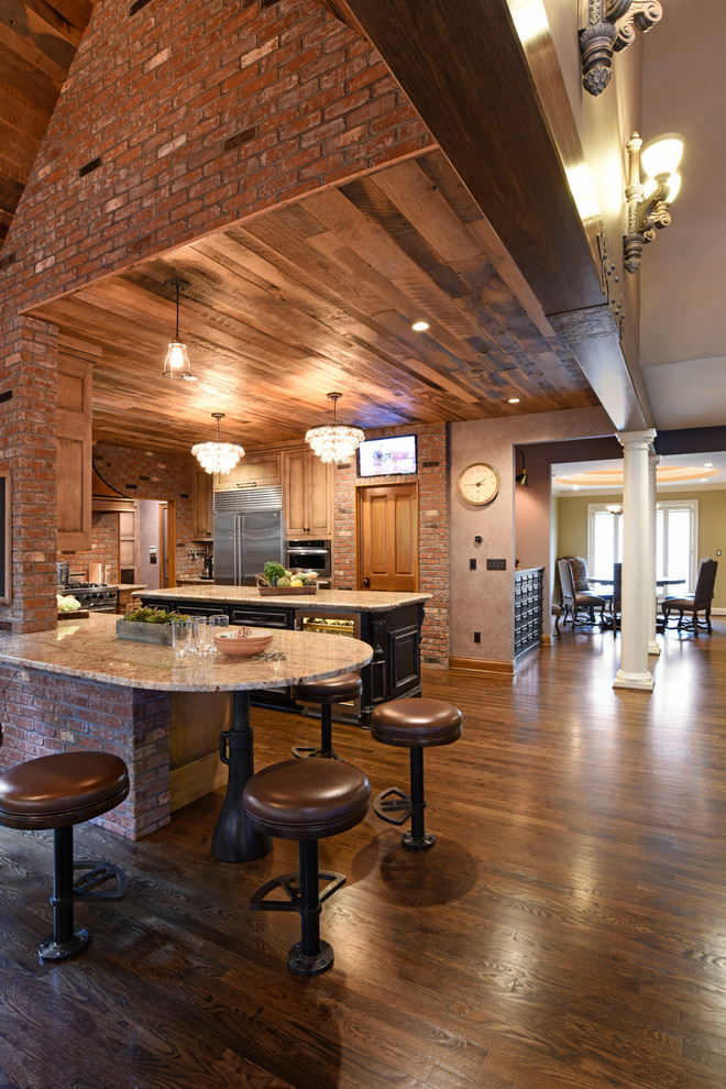 Bild på ett stort rustikt kök och matrum, med granitbänkskiva, rostfria vitvaror och mörkt trägolv