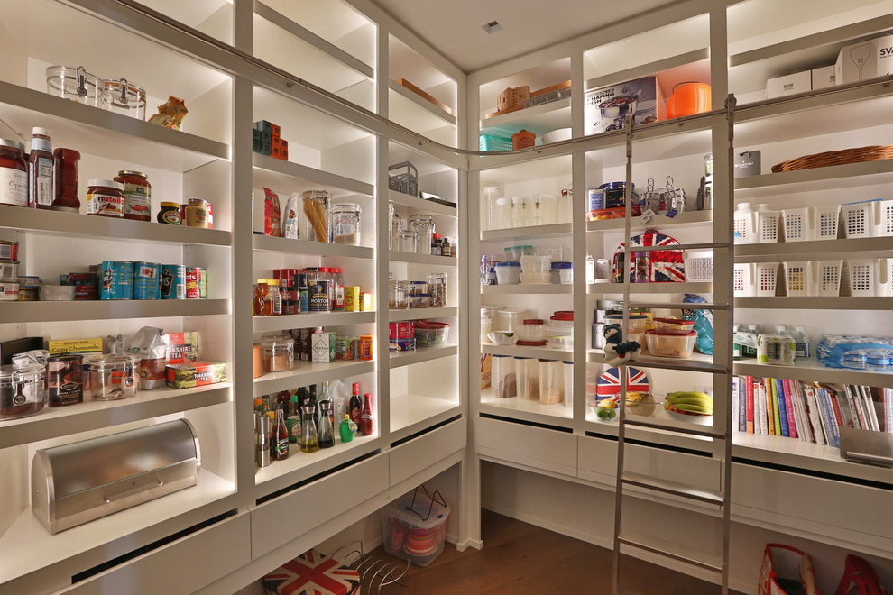 Medium sized modern l-shaped kitchen pantry in Columbus with a submerged sink, flat-panel cabinets, white cabinets, composite countertops, white splashback, integrated appliances, medium hardwood flooring and no island.