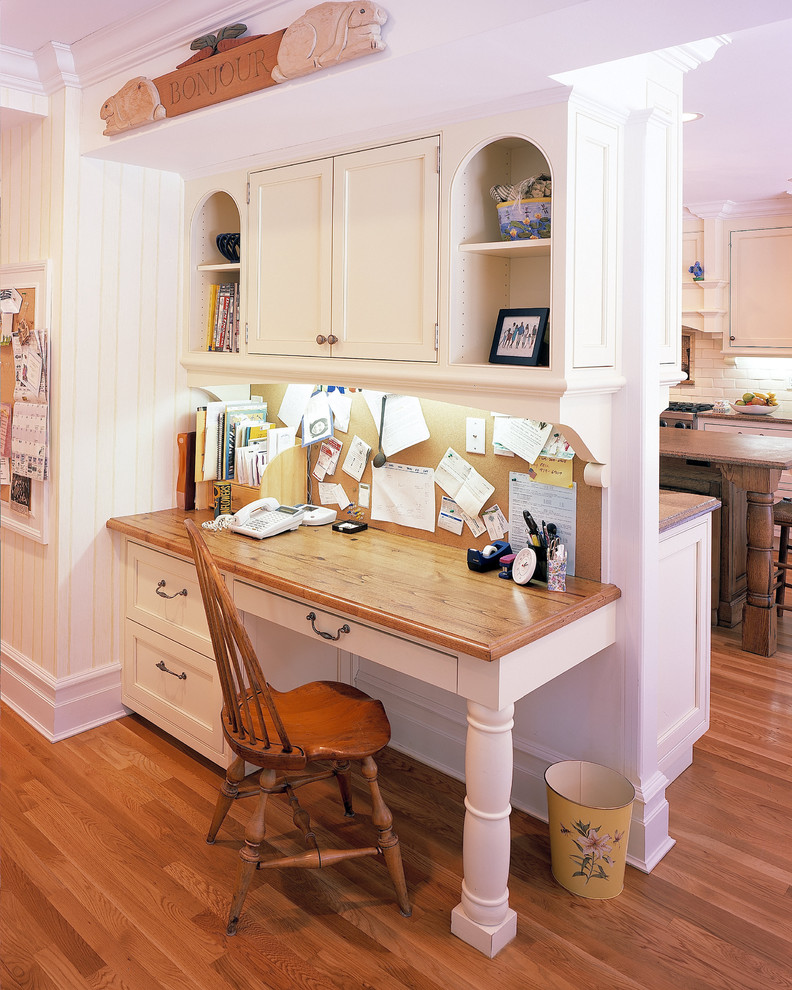 Large elegant medium tone wood floor kitchen photo in New York with wood countertops, shaker cabinets, white cabinets, white backsplash, subway tile backsplash and an island