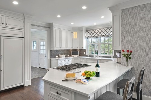Bright white kitchen with peninsula cooktop and window — inspiration for Scratch-Resistant Melamine cabinetry
