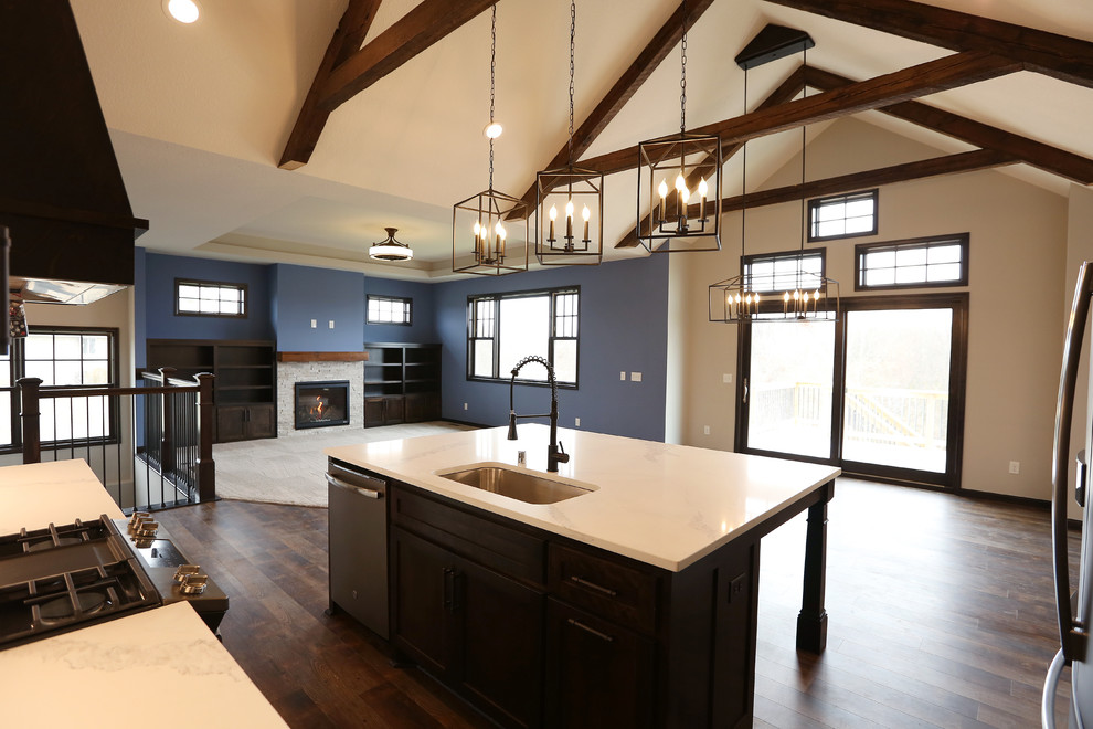 Example of a large arts and crafts l-shaped vinyl floor and brown floor open concept kitchen design in Minneapolis with an undermount sink, shaker cabinets, white cabinets, quartz countertops, white backsplash, subway tile backsplash, stainless steel appliances, an island and white countertops