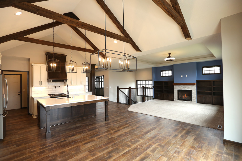Inspiration for a large craftsman vinyl floor and brown floor open concept kitchen remodel in Minneapolis with an undermount sink, shaker cabinets, white cabinets, quartz countertops, white backsplash, subway tile backsplash, stainless steel appliances, an island and white countertops