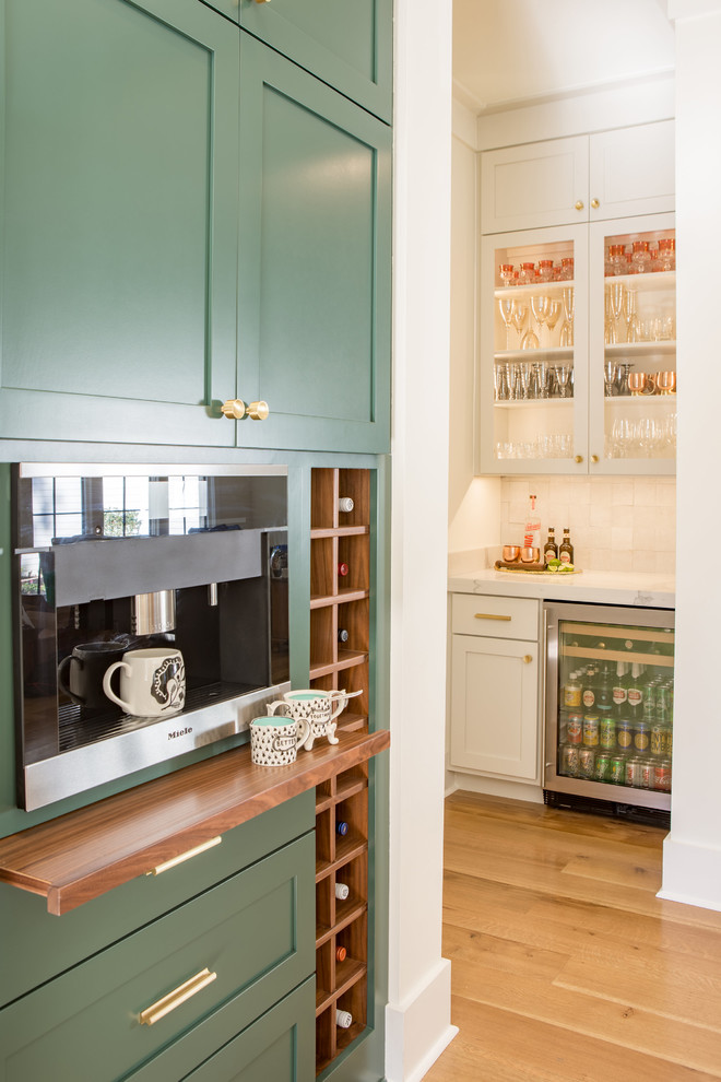 Large transitional u-shaped light wood floor open concept kitchen photo in Other with shaker cabinets, green cabinets, quartz countertops, white backsplash, stainless steel appliances and an island