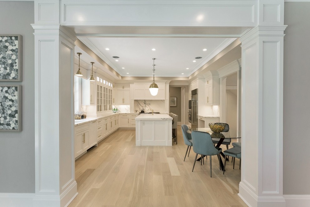 Large transitional u-shaped light wood floor and beige floor eat-in kitchen photo in New York with an undermount sink, recessed-panel cabinets, white cabinets, marble countertops, red backsplash, marble backsplash, stainless steel appliances, an island and white countertops