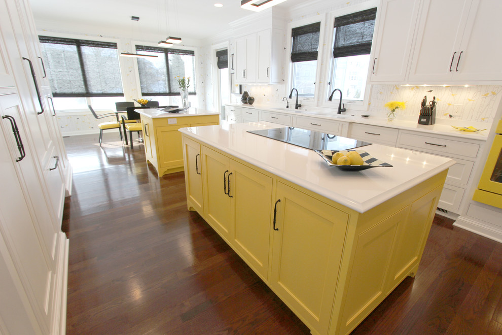 This is an example of an expansive classic galley kitchen/diner in Cleveland with a submerged sink, beaded cabinets, white cabinets, engineered stone countertops, multi-coloured splashback, coloured appliances, medium hardwood flooring and multiple islands.