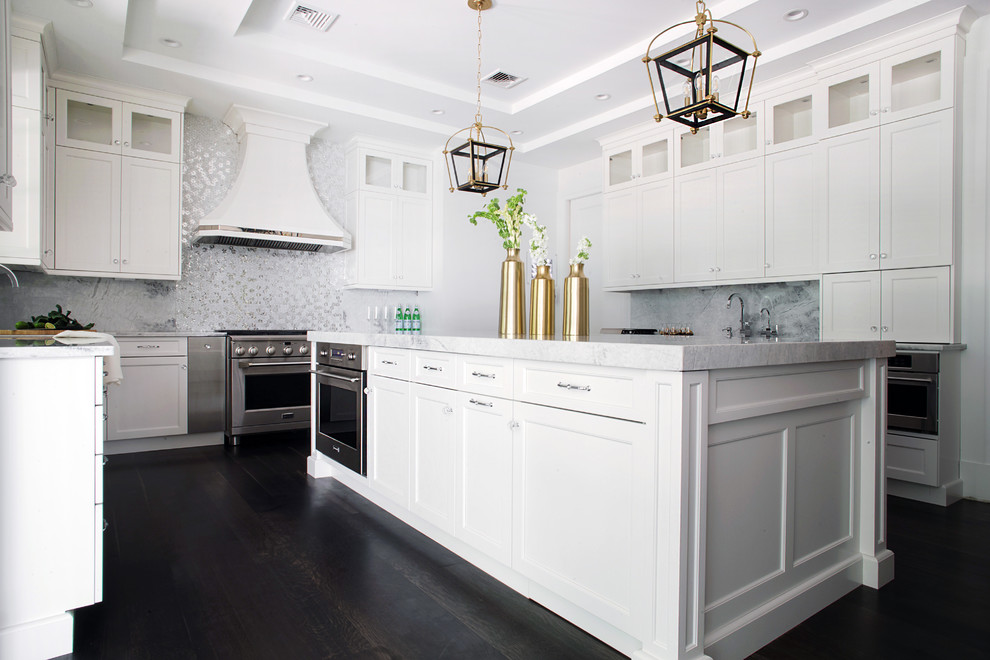 Inspiration for a huge transitional u-shaped medium tone wood floor eat-in kitchen remodel in New York with an undermount sink, recessed-panel cabinets, white cabinets, quartzite countertops, white backsplash, stone tile backsplash, stainless steel appliances and an island