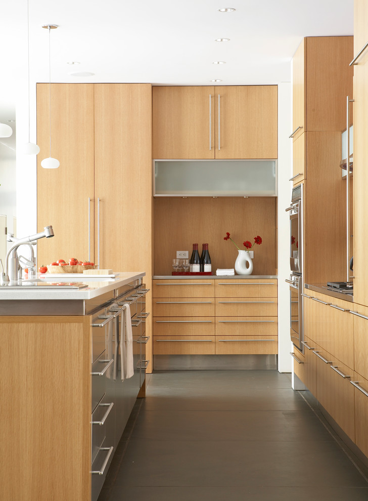 Photo of a contemporary kitchen in New York with concrete flooring, flat-panel cabinets, light wood cabinets and an island.