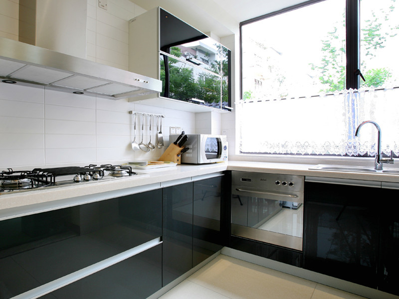 This is an example of a medium sized modern galley kitchen/diner in Other with a double-bowl sink, open cabinets, white cabinets, quartz worktops, white splashback, cement tile splashback, stainless steel appliances, brick flooring and an island.