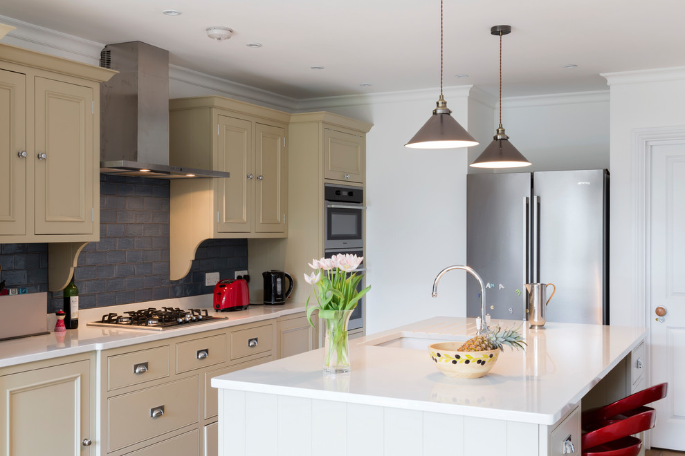 Inspiration for a traditional kitchen in Other with a submerged sink, beaded cabinets, green cabinets, metro tiled splashback, stainless steel appliances, dark hardwood flooring, an island and beige floors.