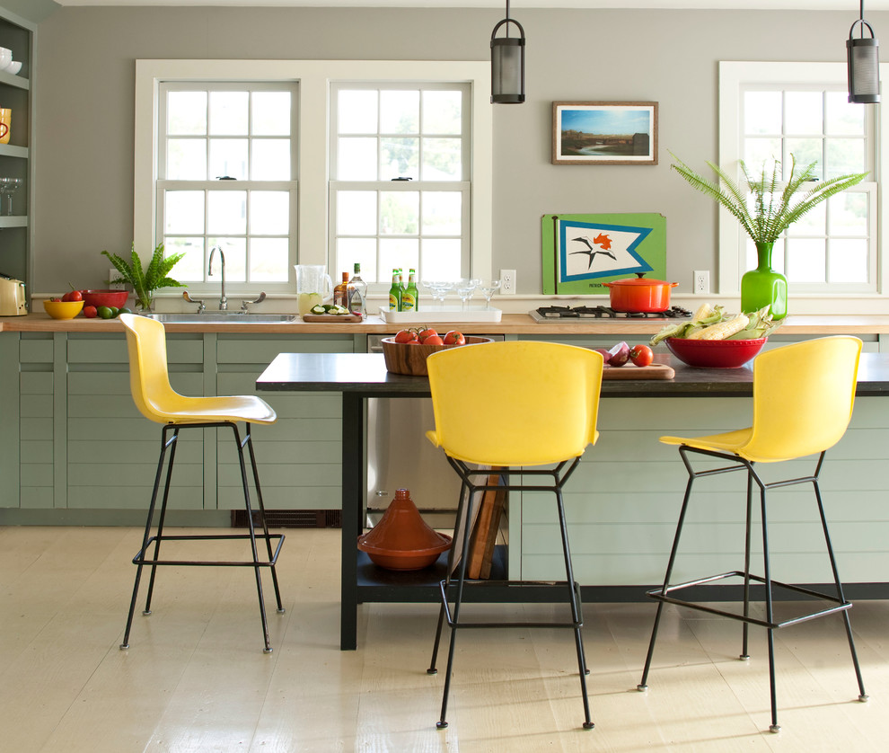Trendy kitchen photo in New York with wood countertops