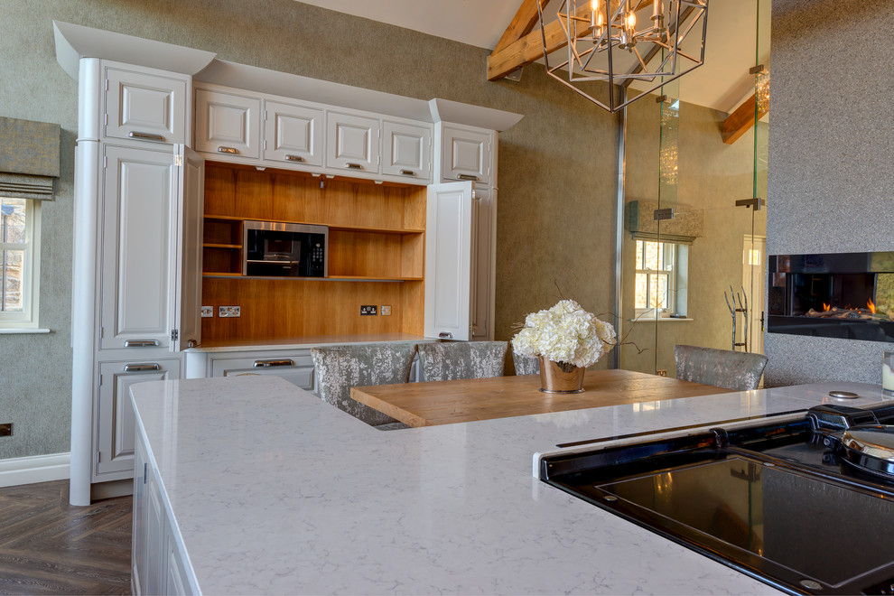 Expansive farmhouse kitchen/diner in Other with a belfast sink, raised-panel cabinets, vinyl flooring and an island.