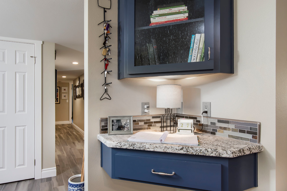 Example of a mid-sized transitional galley ceramic tile and gray floor eat-in kitchen design in Los Angeles with a farmhouse sink, shaker cabinets, white cabinets, granite countertops, multicolored backsplash, glass tile backsplash, stainless steel appliances, no island and multicolored countertops