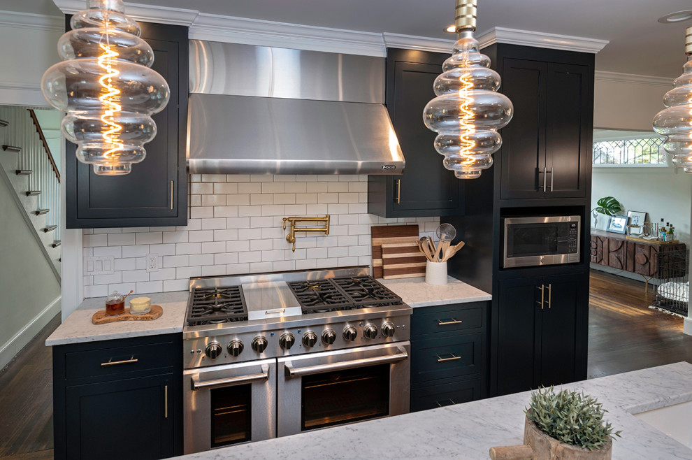 Small minimalist galley dark wood floor and brown floor eat-in kitchen photo in Bridgeport with a farmhouse sink, shaker cabinets, blue cabinets, marble countertops, white backsplash, ceramic backsplash, stainless steel appliances, an island and white countertops