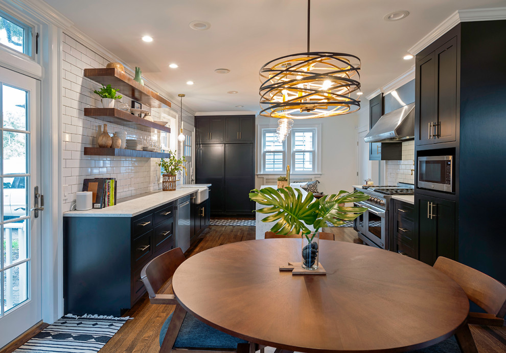 Example of a small minimalist galley dark wood floor and brown floor eat-in kitchen design in Bridgeport with a farmhouse sink, shaker cabinets, blue cabinets, marble countertops, white backsplash, ceramic backsplash, stainless steel appliances, an island and white countertops