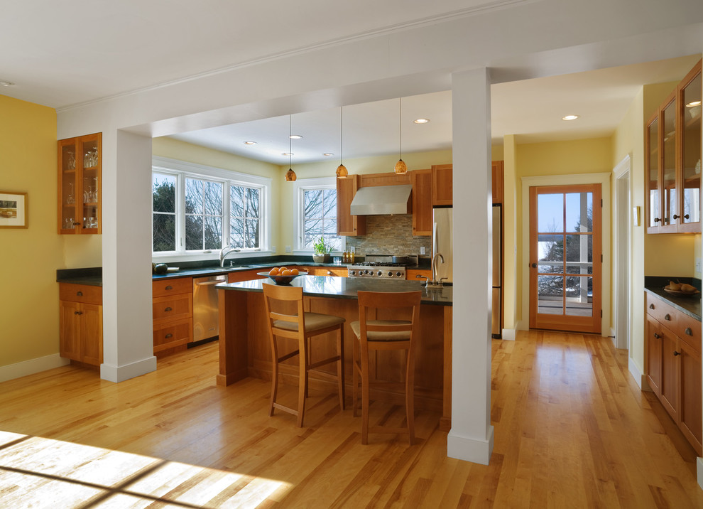 Inspiration for a large cottage l-shaped light wood floor and brown floor eat-in kitchen remodel in Burlington with a drop-in sink, flat-panel cabinets, light wood cabinets, granite countertops, multicolored backsplash, ceramic backsplash, stainless steel appliances and an island
