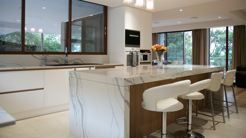 Eat-in kitchen - large modern l-shaped ceramic tile and multicolored floor eat-in kitchen idea in Sydney with an undermount sink, recessed-panel cabinets, white cabinets, quartz countertops, multicolored backsplash, stone slab backsplash, white appliances, an island and multicolored countertops