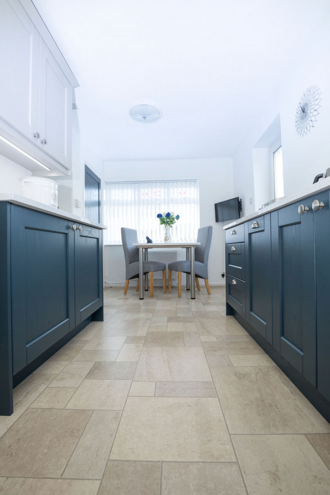 This is an example of a medium sized classic kitchen in Oxfordshire with a built-in sink, shaker cabinets, quartz worktops, white splashback, engineered quartz splashback, stainless steel appliances and white worktops.