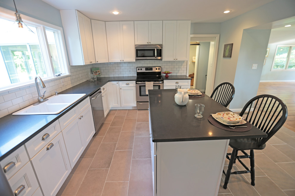 Example of a large transitional l-shaped porcelain tile eat-in kitchen design in Philadelphia with a double-bowl sink, recessed-panel cabinets, white cabinets, quartzite countertops, white backsplash, subway tile backsplash, stainless steel appliances and an island