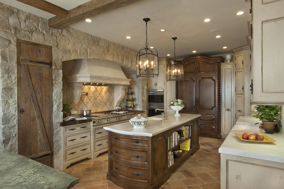 Large tuscan u-shaped marble floor and brown floor enclosed kitchen photo in San Diego with paneled appliances, beige cabinets, an undermount sink, recessed-panel cabinets, marble countertops, beige backsplash, stone tile backsplash and an island