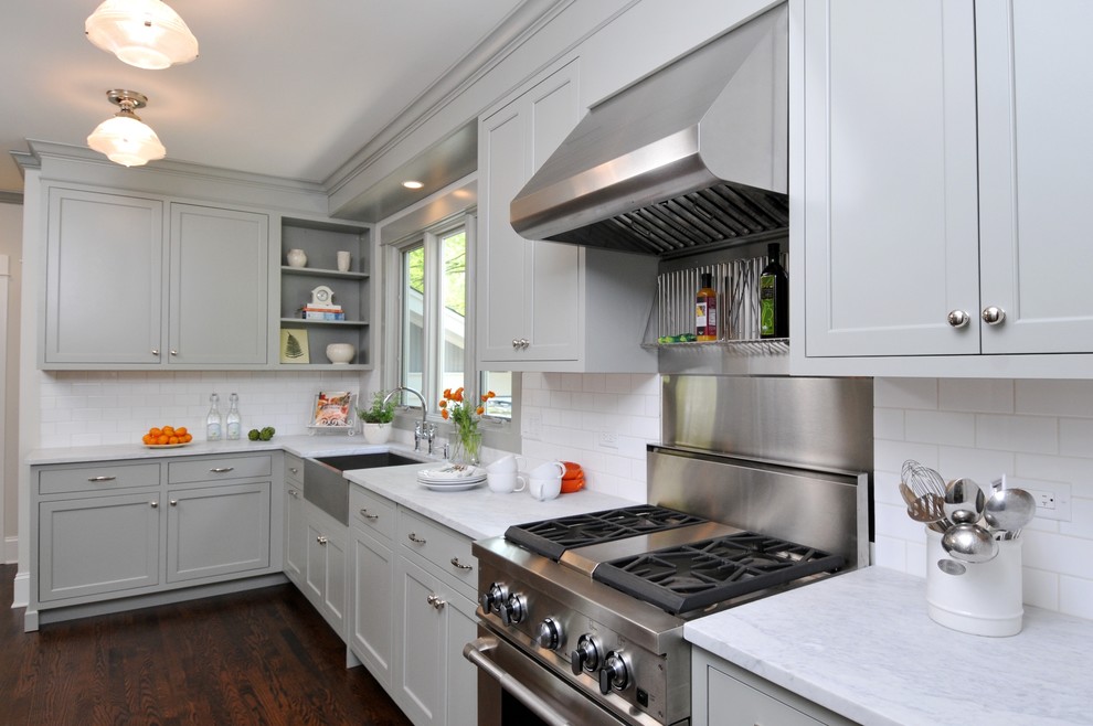 This is an example of a medium sized classic galley enclosed kitchen in Chicago with stainless steel appliances, metro tiled splashback, a belfast sink, marble worktops, shaker cabinets, white splashback, dark hardwood flooring, no island and grey cabinets.