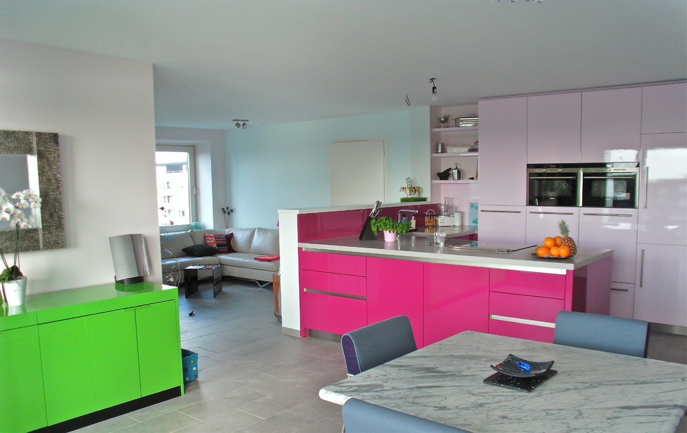 Mid-sized minimalist l-shaped ceramic tile open concept kitchen photo in Amsterdam with a single-bowl sink, flat-panel cabinets, red cabinets, quartzite countertops, pink backsplash and black appliances