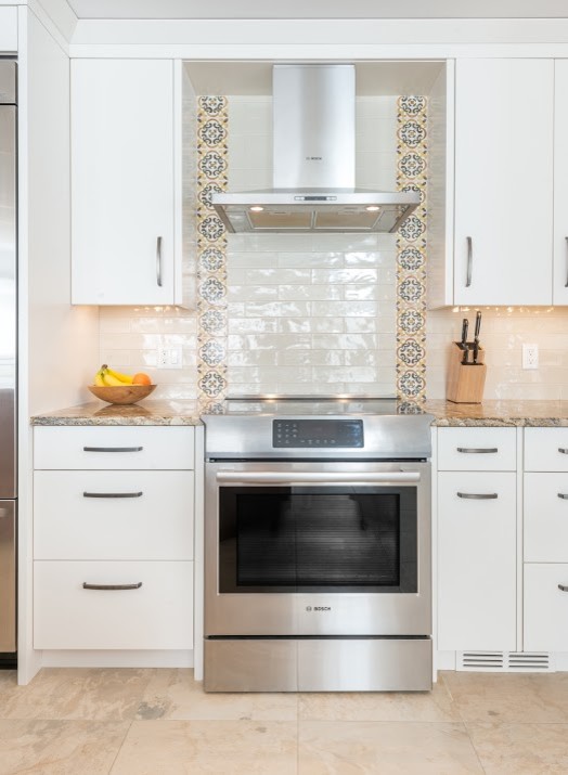 Eat-in kitchen - large transitional l-shaped marble floor eat-in kitchen idea in Toronto with an undermount sink, flat-panel cabinets, white cabinets, granite countertops, white backsplash, subway tile backsplash, stainless steel appliances and an island