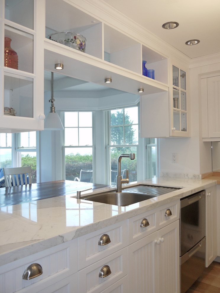 Example of a mid-sized classic galley medium tone wood floor and brown floor eat-in kitchen design in Boston with louvered cabinets, white cabinets, wood countertops, blue backsplash, matchstick tile backsplash, stainless steel appliances and no island