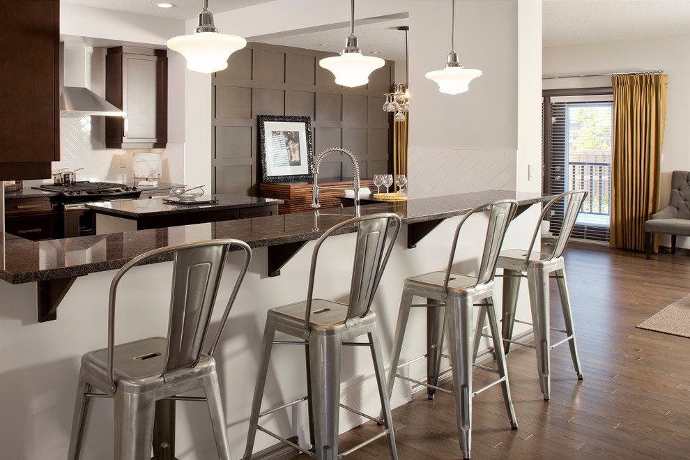 This is an example of a contemporary u-shaped kitchen/diner in Edmonton with stainless steel appliances.
