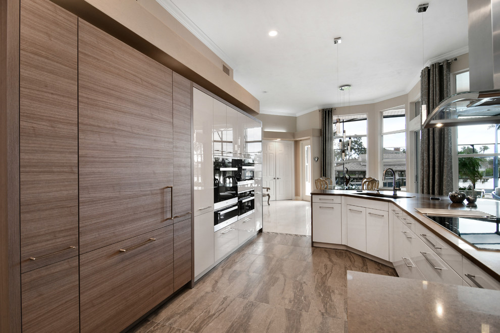 Eat-in kitchen - mid-sized contemporary l-shaped ceramic tile eat-in kitchen idea in Orlando with an undermount sink, flat-panel cabinets, medium tone wood cabinets, quartz countertops, brown backsplash, paneled appliances and an island