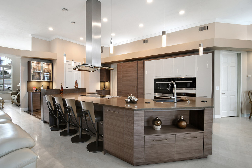 Example of a mid-sized trendy l-shaped ceramic tile eat-in kitchen design in Orlando with an undermount sink, flat-panel cabinets, medium tone wood cabinets, quartz countertops, brown backsplash, paneled appliances and an island