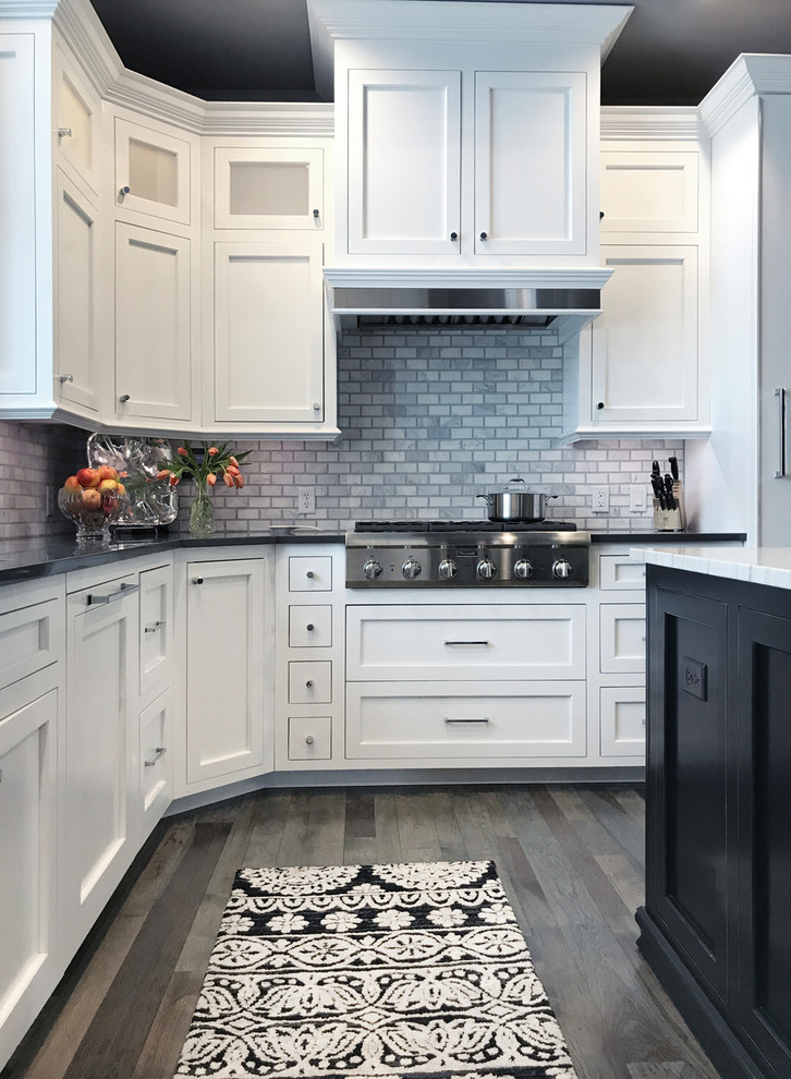 Inspiration for a large transitional u-shaped eat-in kitchen remodel in Other with marble backsplash and an island