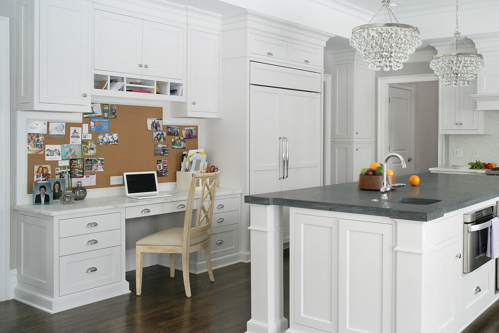 Inspiration for a transitional u-shaped dark wood floor kitchen remodel in New York with an integrated sink, shaker cabinets, white cabinets, paneled appliances and an island