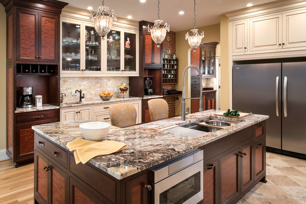 Photo of a large victorian enclosed kitchen in Atlanta with a belfast sink, raised-panel cabinets, granite worktops, beige splashback, marble splashback, stainless steel appliances and an island.