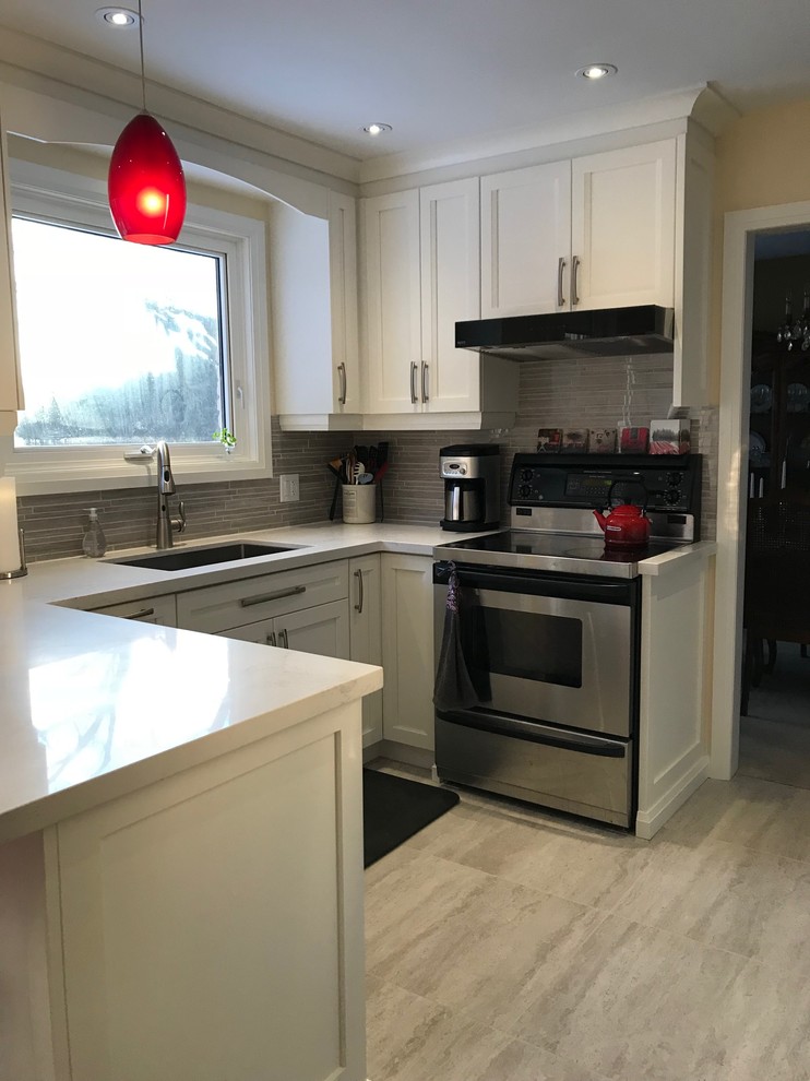 Photo of a small contemporary galley kitchen/diner in Toronto with a submerged sink, flat-panel cabinets, white cabinets, engineered stone countertops, grey splashback, marble splashback, stainless steel appliances, porcelain flooring, no island and grey floors.