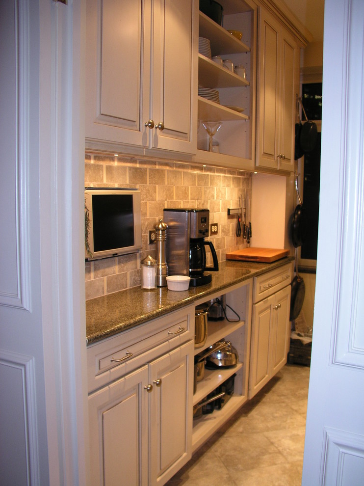 Example of a small transitional galley ceramic tile enclosed kitchen design in New York with raised-panel cabinets, granite countertops, ceramic backsplash, stainless steel appliances and no island
