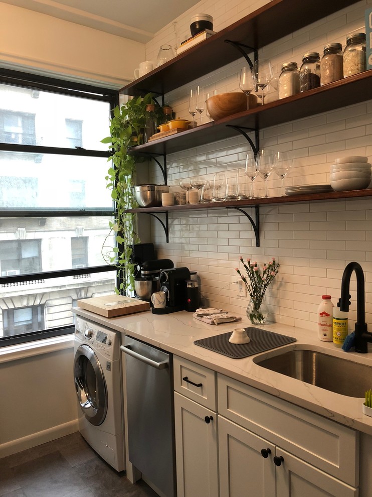 Small trendy ceramic tile and brown floor eat-in kitchen photo in New York with a drop-in sink, shaker cabinets, white cabinets, quartz countertops, white backsplash, ceramic backsplash, stainless steel appliances, no island and white countertops