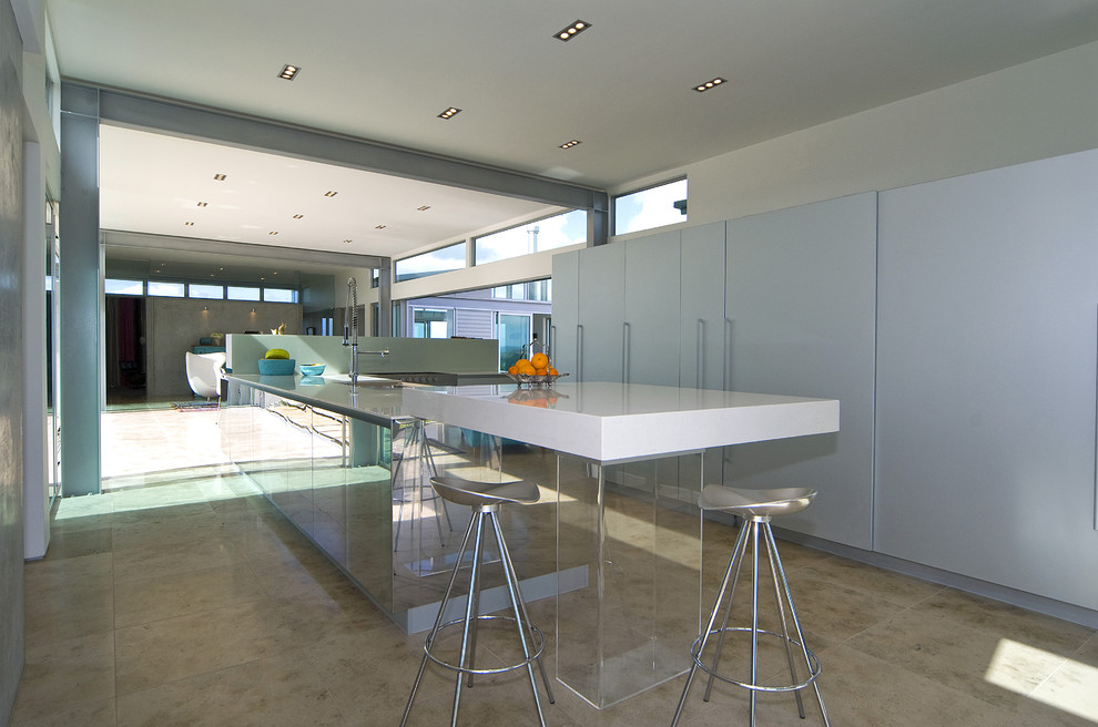 This is an example of a contemporary kitchen in Auckland with flat-panel cabinets and blue cabinets.