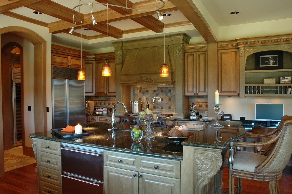 This is an example of a large traditional u-shaped open plan kitchen in Seattle with raised-panel cabinets, medium wood cabinets, granite worktops, brown splashback, stone tiled splashback, stainless steel appliances, medium hardwood flooring and an island.