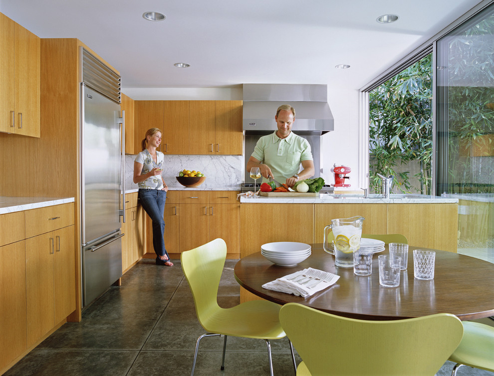 Example of a minimalist kitchen design in Los Angeles with stainless steel appliances