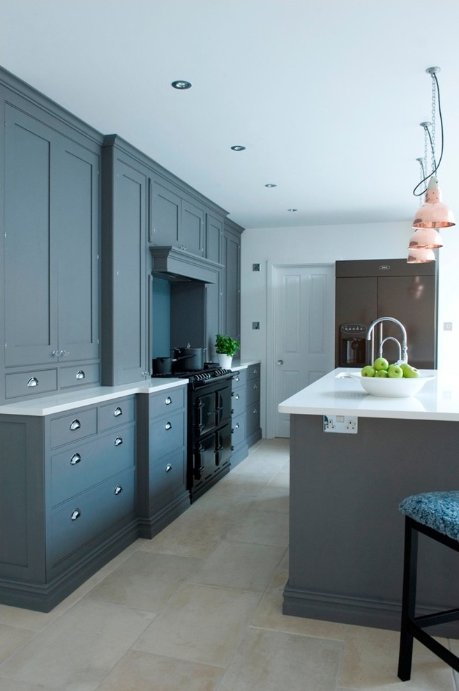 Inspiration for a classic open plan kitchen in London with a built-in sink, shaker cabinets, grey cabinets, black appliances and an island.