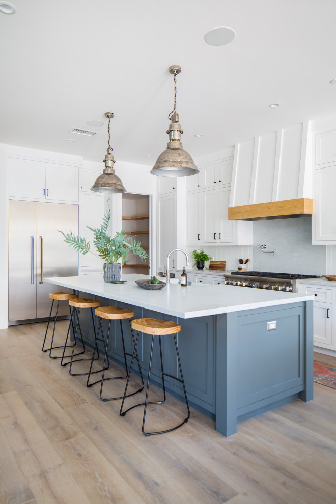 Medium sized farmhouse open plan kitchen in Orange County with shaker cabinets, grey cabinets, marble worktops, stainless steel appliances, an island and white worktops.