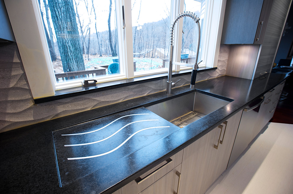 This is an example of a large traditional u-shaped kitchen/diner in New York with a submerged sink, concrete worktops, white splashback, stainless steel appliances and an island.