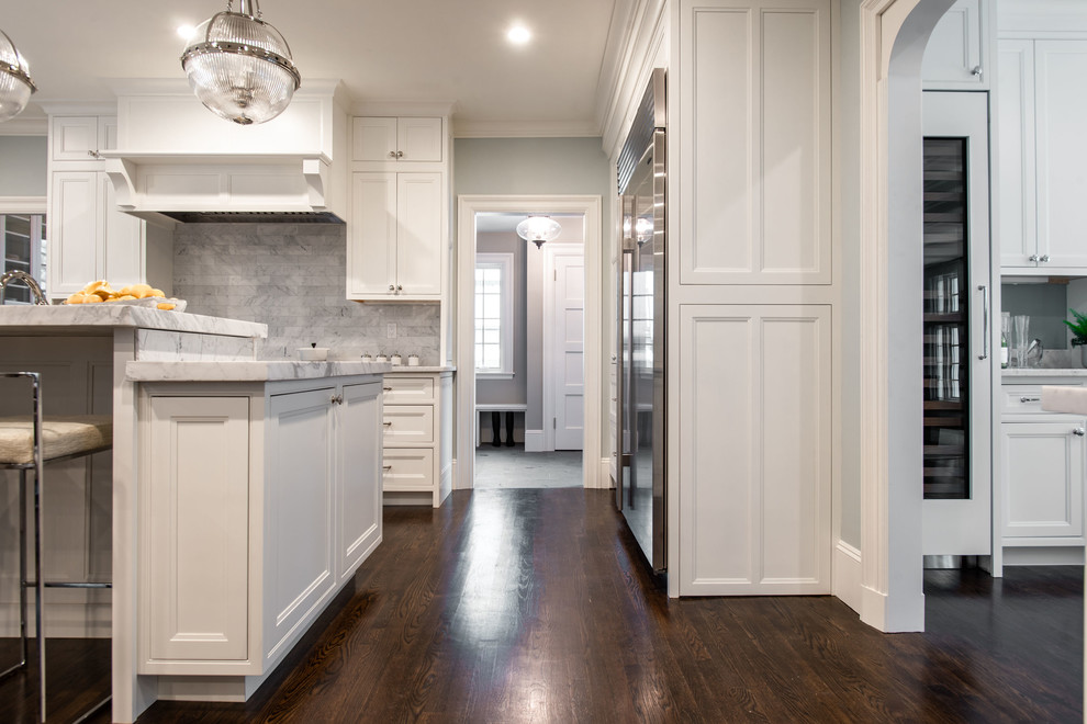 Eat-in kitchen - huge traditional l-shaped dark wood floor and brown floor eat-in kitchen idea in Boston with an undermount sink, beaded inset cabinets, white cabinets, marble countertops, gray backsplash, marble backsplash, stainless steel appliances, an island and white countertops